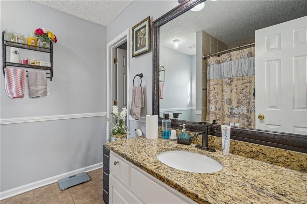 4496 Jackam Ridge Court Lithonia, GA 30038 - Photo 22 of 24 a bathroom with a granite countertop sink and a mirror