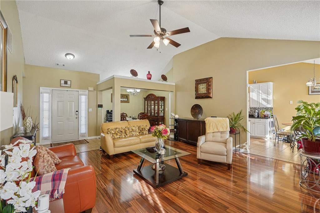 4496 Jackam Ridge Court Lithonia, GA 30038 - Photo 5 of 24 a living room with furniture and a chandelier