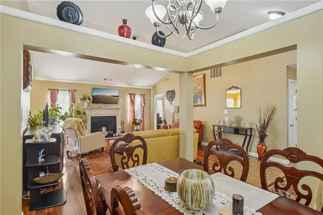 a bedroom with furniture a fireplace and a chandelier