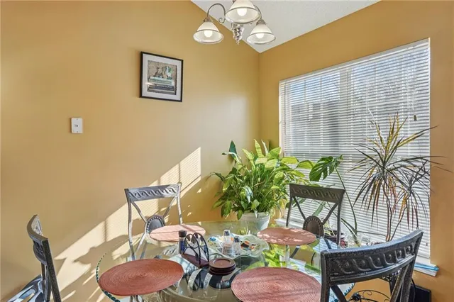 a dining room with furniture and wooden floor