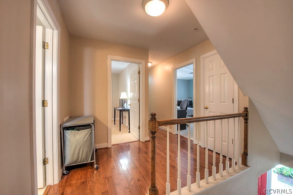 13908 Shadow Ridge Lane Midlothian, VA 23112 - Photo 20 of 35 a view of a hallway with wooden floor and staircase