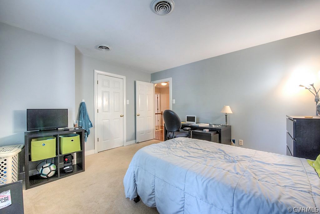 13908 Shadow Ridge Lane Midlothian, VA 23112 - Photo 29 of 35 a bedroom with a bed and a flat screen tv