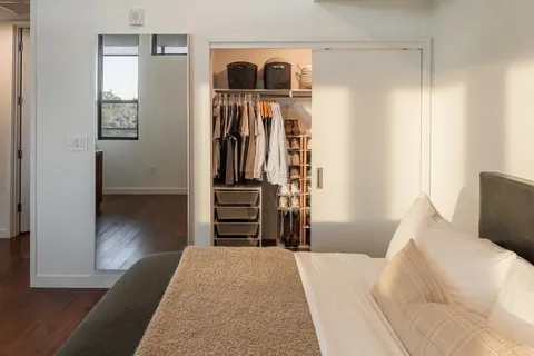 a bedroom with a bed and a walk in closet