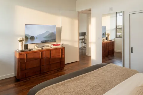 a bedroom with a bed and wooden floor