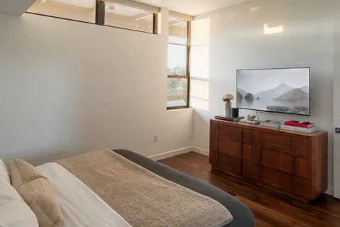 a bedroom with a bed and a flat screen tv