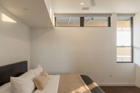 a bed room with a bed and a window