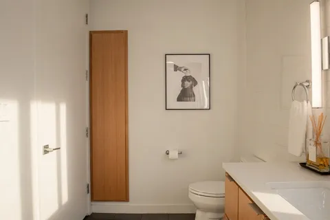a bathroom with a toilet a sink and a mirror