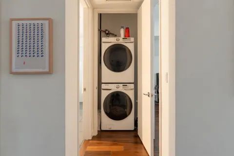 a view of a hallway with washer and dryer