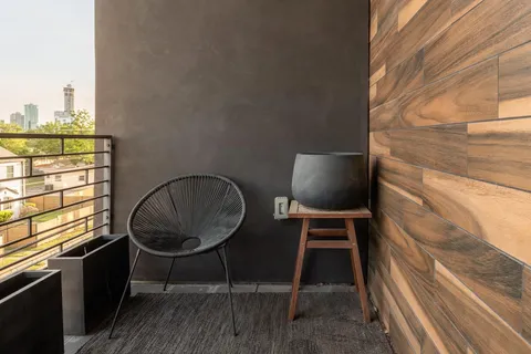 a balcony with table and chairs