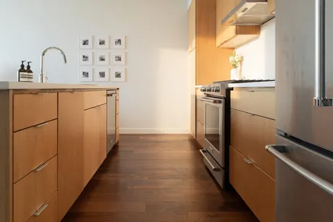 a kitchen with a refrigerator and a sink