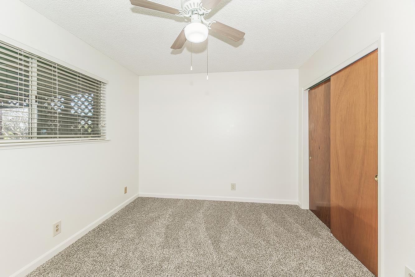 1064 East Early Avenue Reedley, CA 93654 - Photo 13 of 36 an empty room with a window and a fan