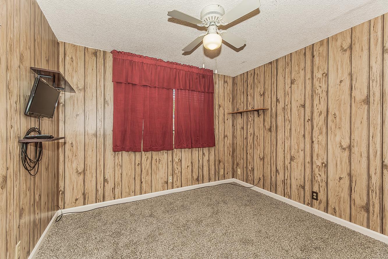 1064 East Early Avenue Reedley, CA 93654 - Photo 20 of 36 a view of a hallway with a ceiling fan
