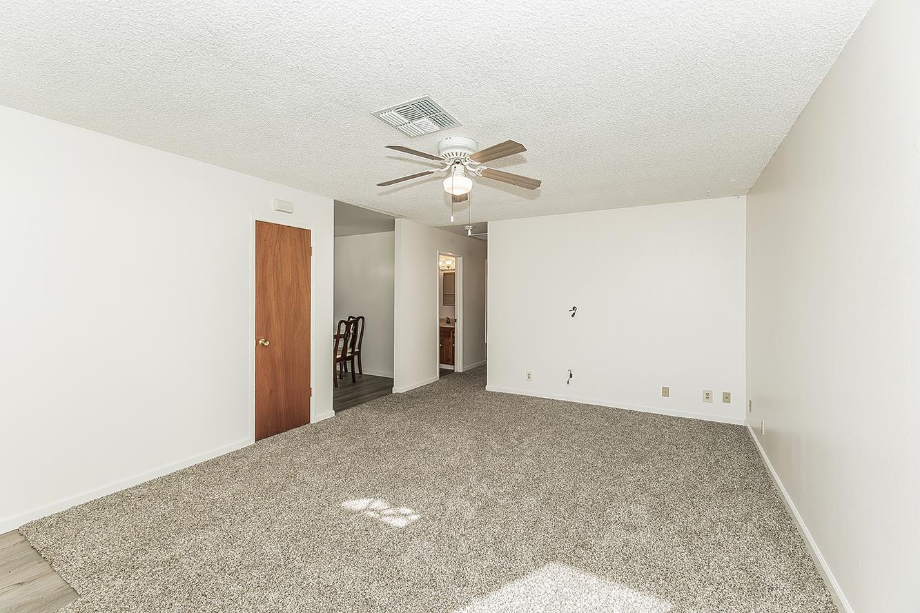 1064 East Early Avenue Reedley, CA 93654 - Photo 3 of 36 an empty room with fan and a ceiling fan