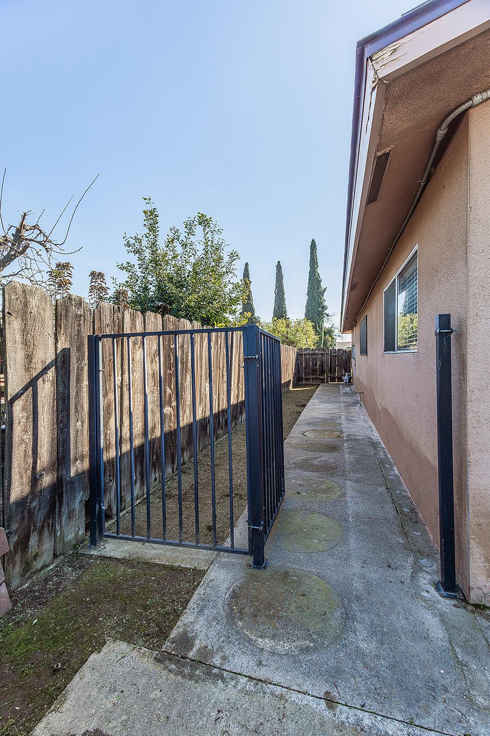 1064 East Early Avenue Reedley, CA 93654 - Photo 31 of 36 a view of a porch with wooden floor and fence