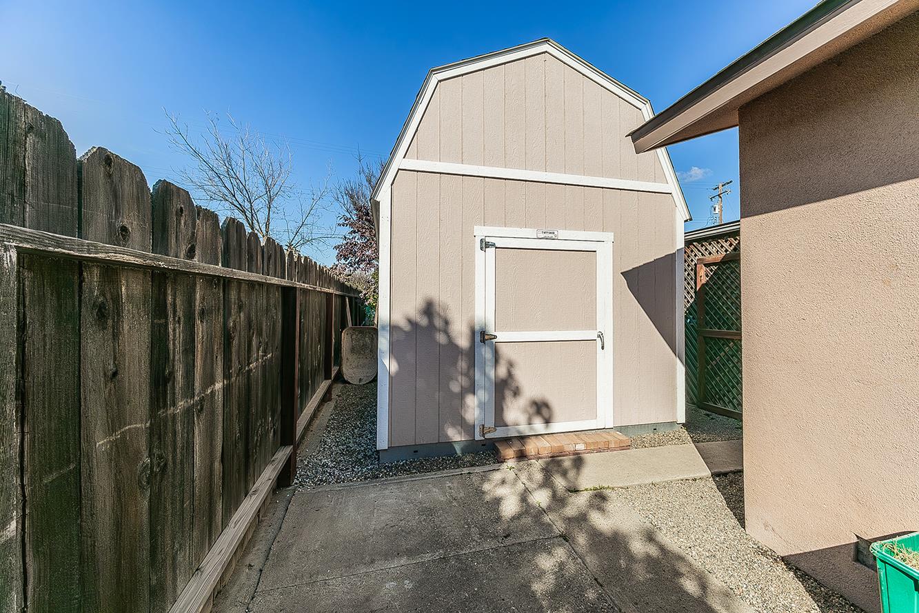 1064 East Early Avenue Reedley, CA 93654 - Photo 33 of 36 a view of a house with a wooden fence