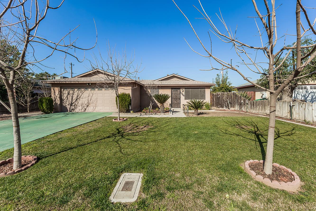 1064 East Early Avenue Reedley, CA 93654 - Photo 35 of 36 a front view of a house with a yard