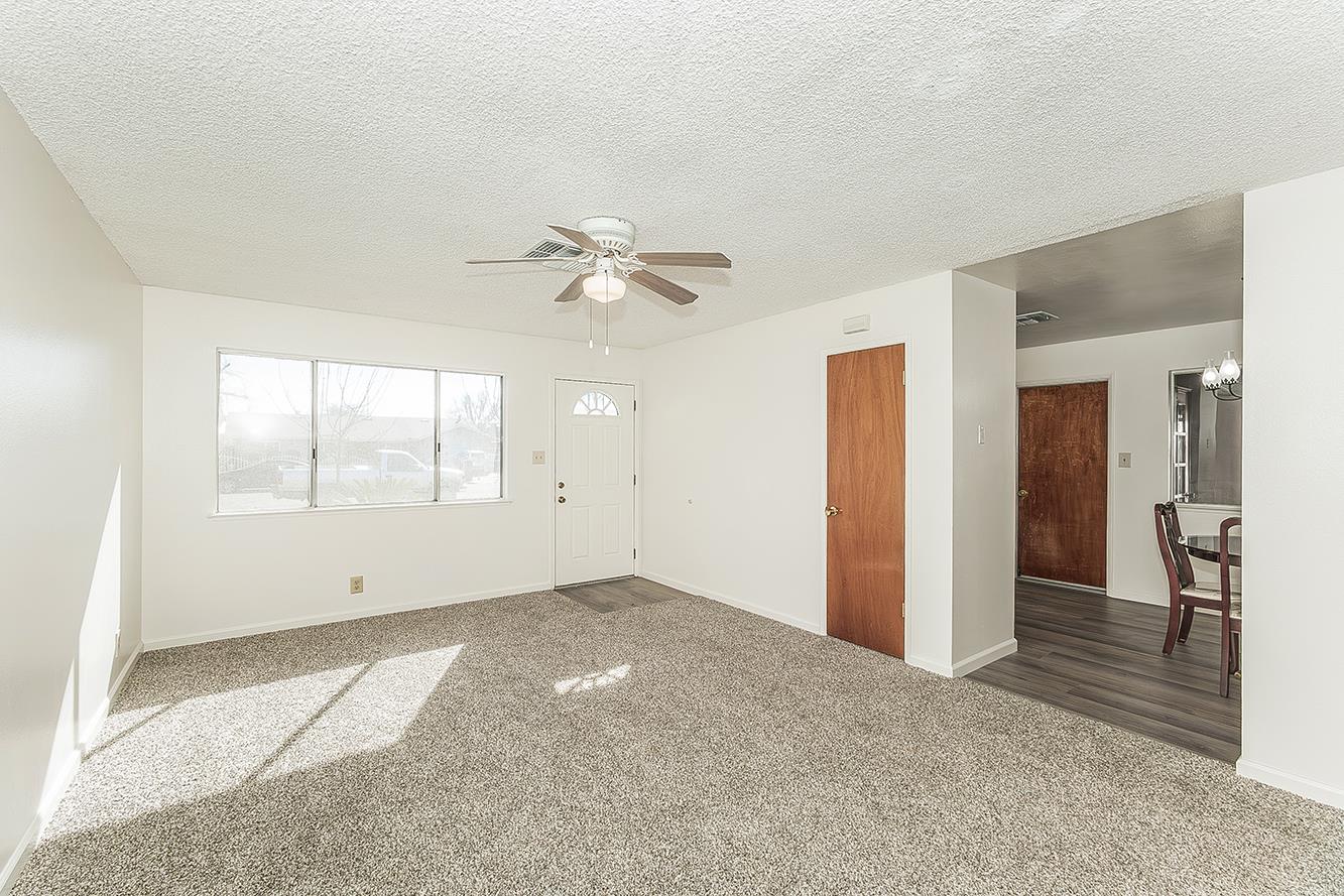 1064 East Early Avenue Reedley, CA 93654 - Photo 4 of 36 an empty room with fan and windows