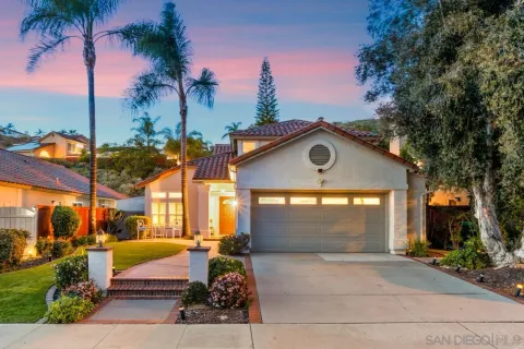 a view of a house with palm trees