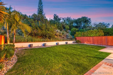 a patio with glass top table and chairs
