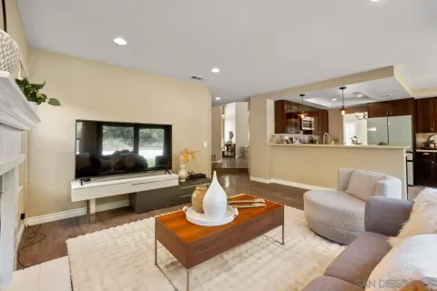 a dining room with furniture a chandelier and wooden floor