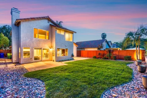 a front view of house with yard and outdoor seating