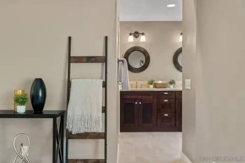 a bathroom with a granite countertop double vanity sink and a mirror