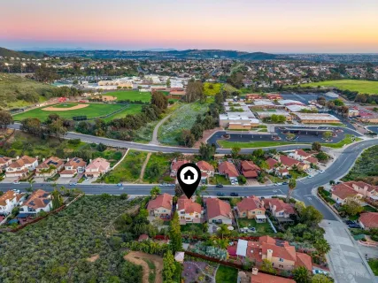 an aerial view of multiple houses with a yard