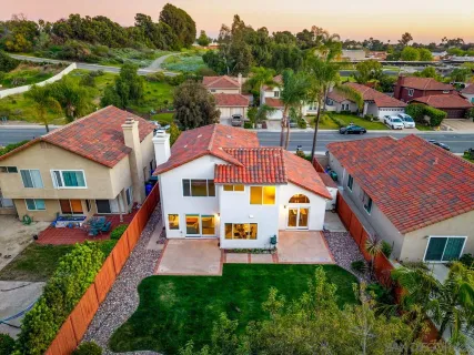 a view of a yard with wooden fence