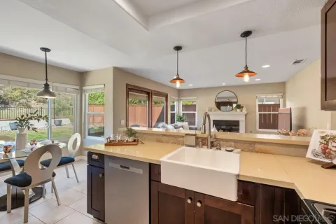 a kitchen with sink refrigerator and dining table