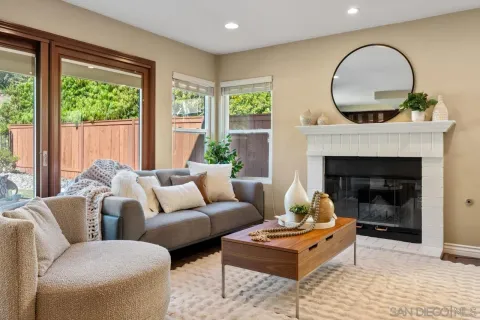 a living room with furniture a window and a fireplace