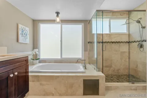 a bathroom with a bathtub and a shower