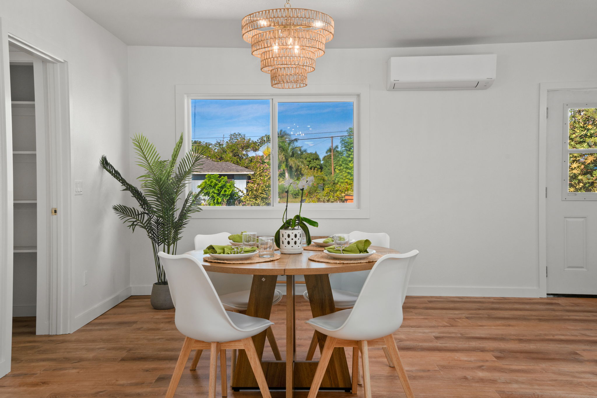 8556 Elepaio Road, Unit B Kekaha, HI 96752 - Photo 11 of 24 a view of a dining room with furniture wooden floor and chandelier