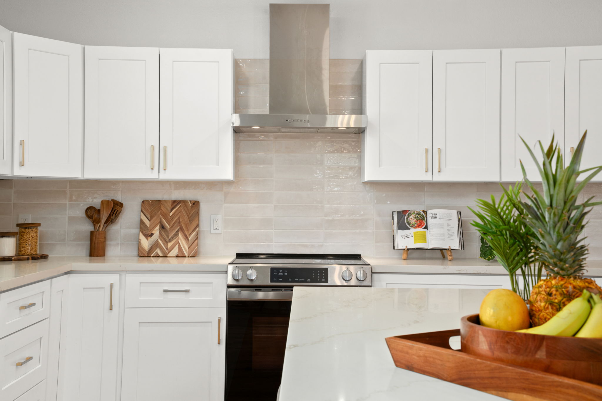 8556 Elepaio Road, Unit B Kekaha, HI 96752 - Photo 14 of 24 a kitchen with stainless steel appliances granite countertop a stove a sink a refrigerator and white cabinets