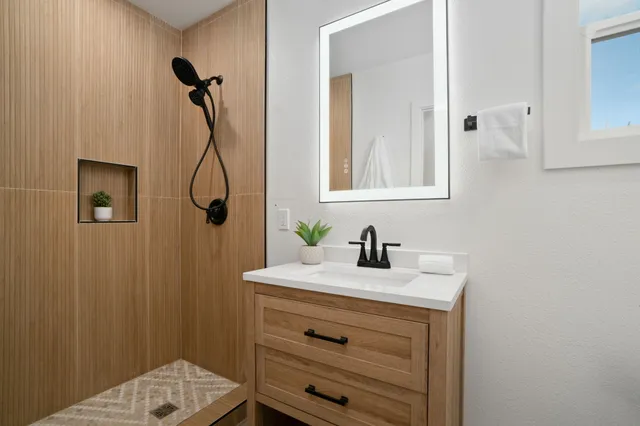 a bathroom with a sink a vanity and a mirror