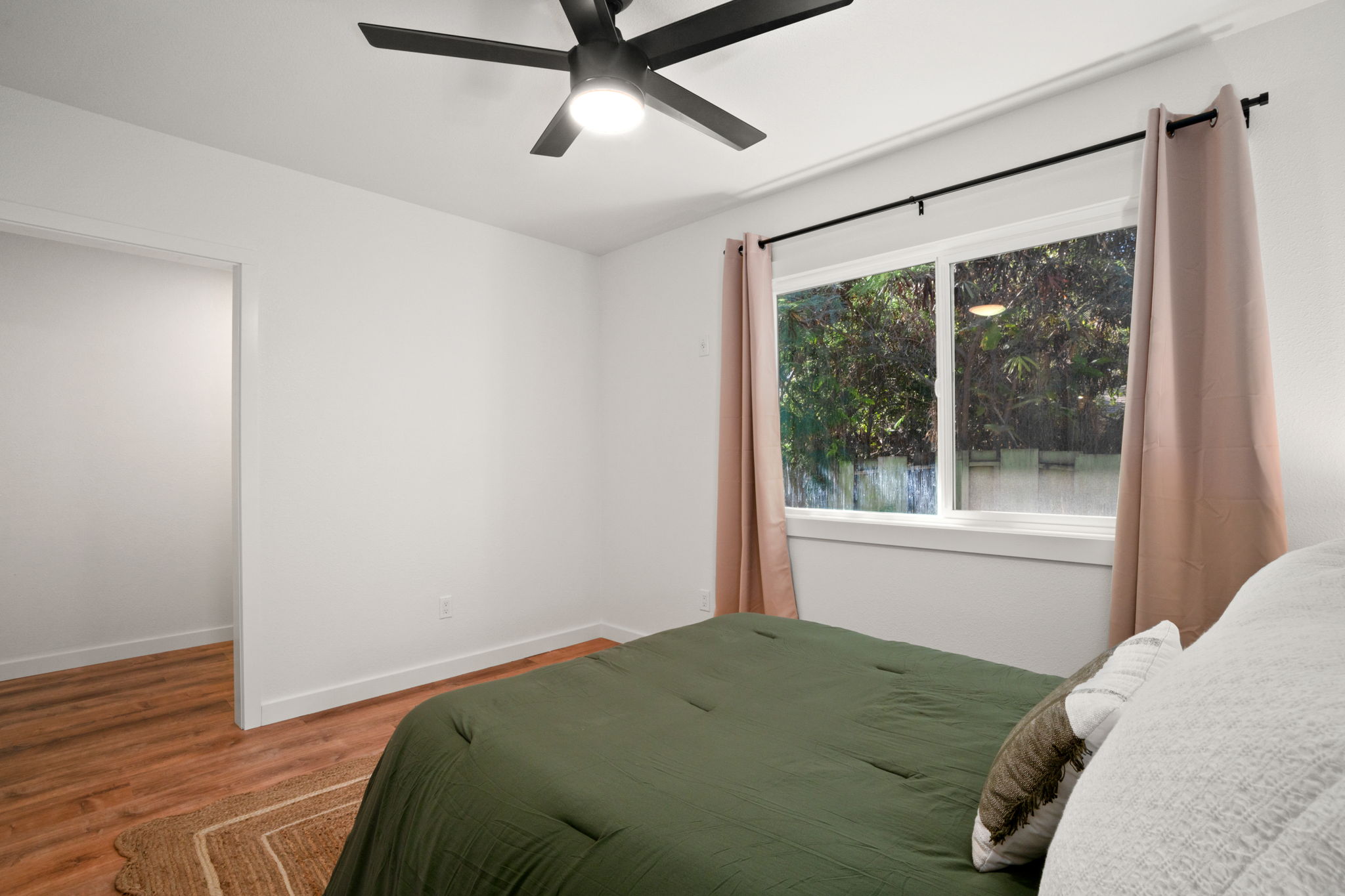 8556 Elepaio Road, Unit B Kekaha, HI 96752 - Photo 17 of 24 a bedroom with a bed and a window