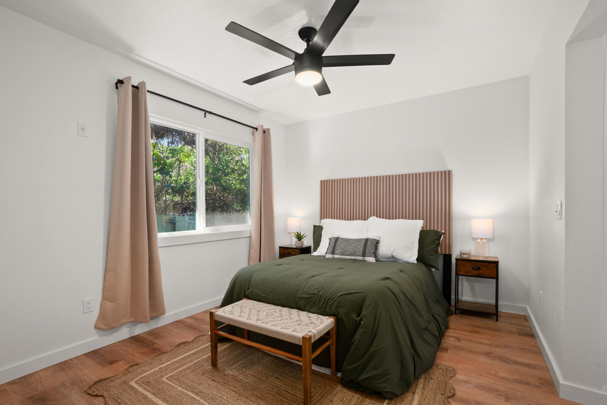 8556 Elepaio Road, Unit B Kekaha, HI 96752 - Photo 18 of 24 a bedroom with a bed window and a table