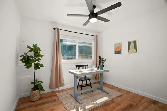 a workspace with furniture and a potted plant