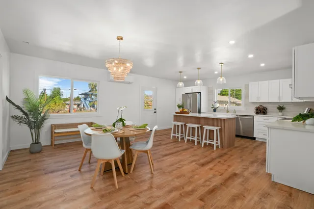 a view of a dining room with furniture and chandelier