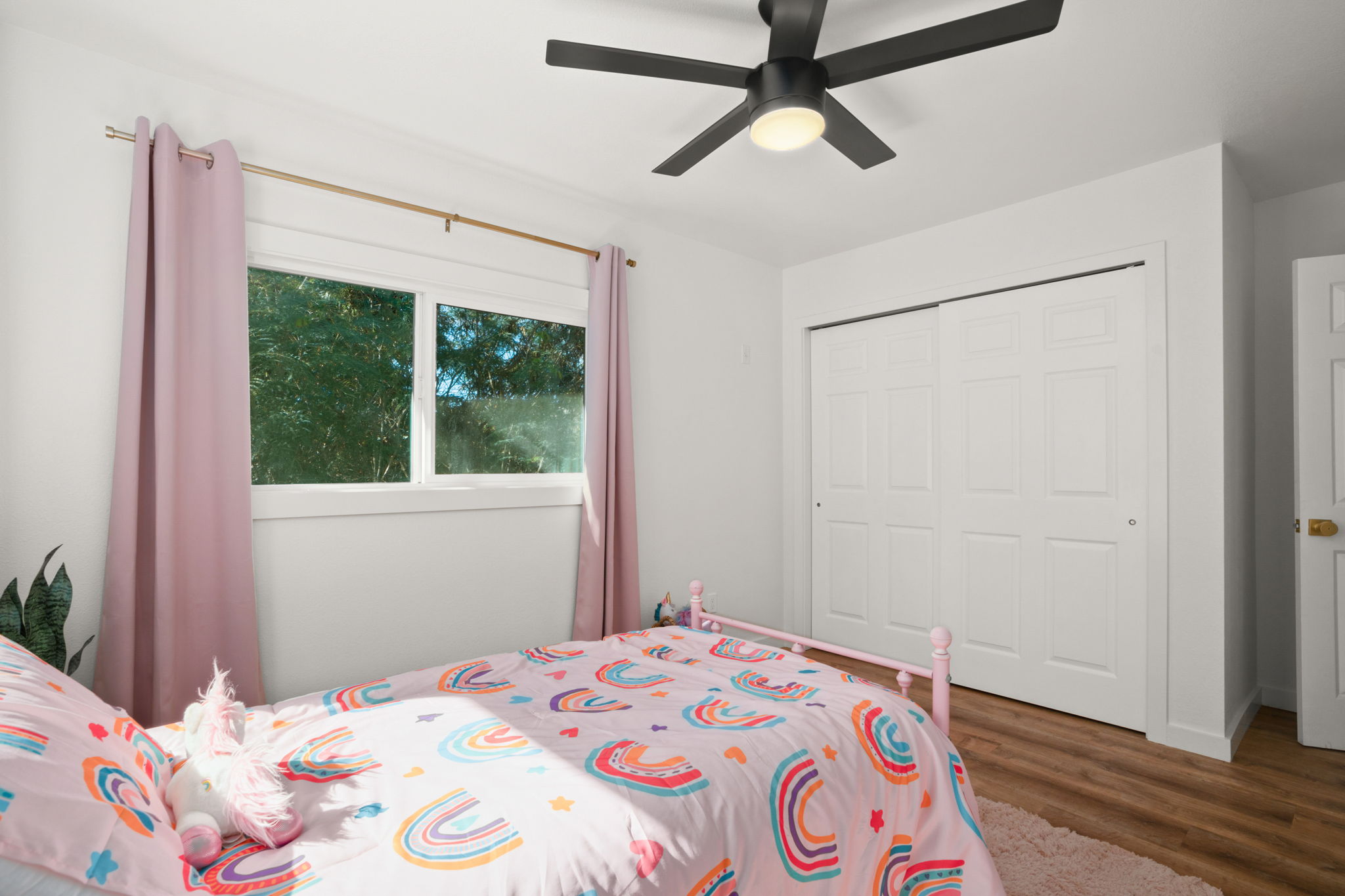 8556 Elepaio Road, Unit B Kekaha, HI 96752 - Photo 23 of 24 a bedroom with a bed and a window