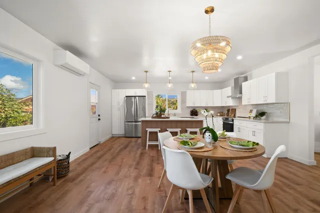 a view of a dining room with furniture wooden floor and chandelier