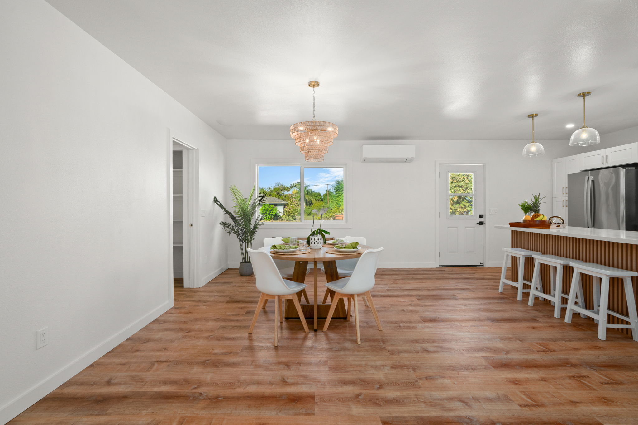 8556 Elepaio Road, Unit B Kekaha, HI 96752 - Photo 8 of 24 a dining room with furniture a chandelier and wooden floor