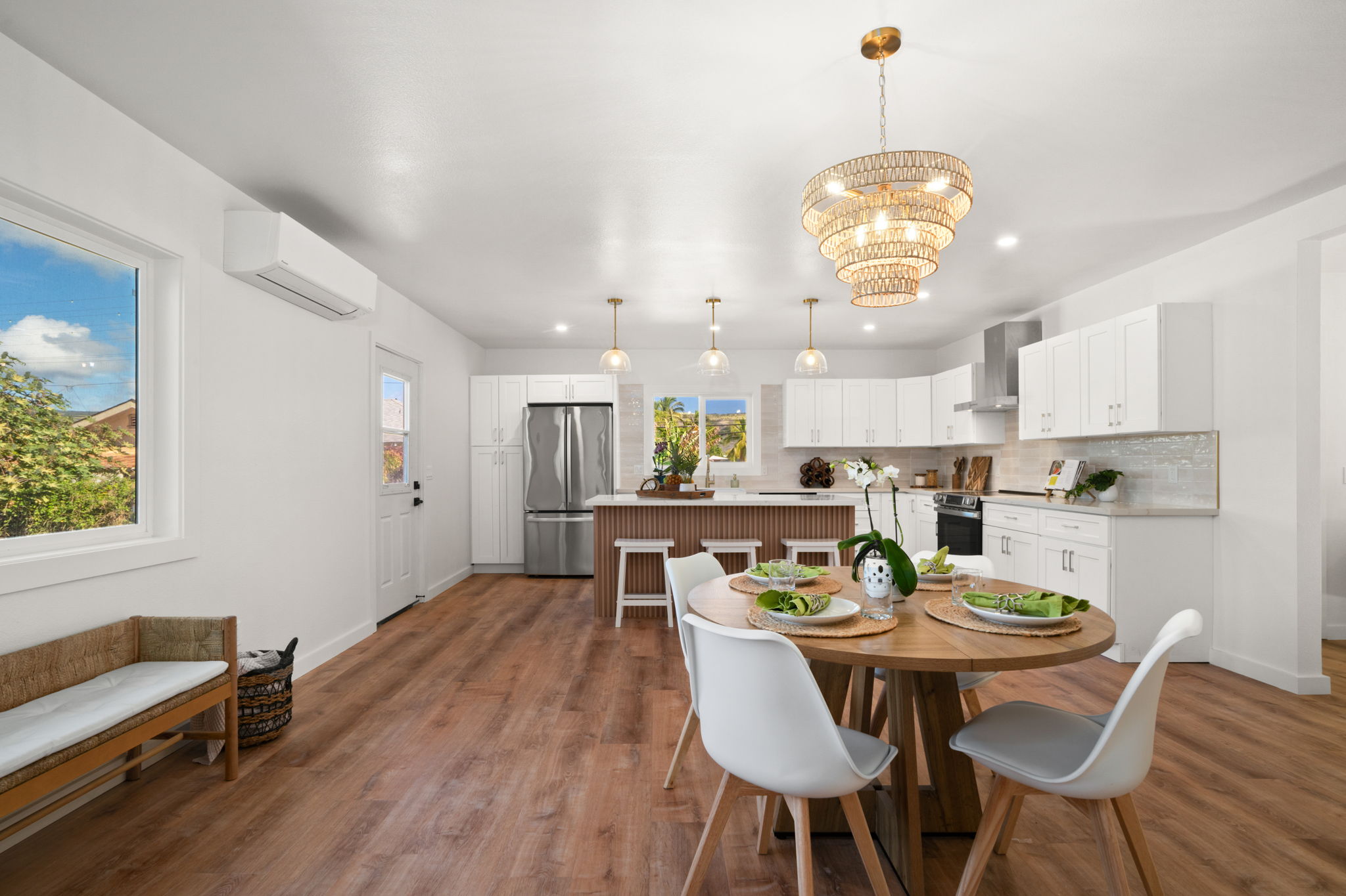 8556 Elepaio Road, Unit B Kekaha, HI 96752 - Photo 10 of 24 a view of a dining room with furniture a chandelier and wooden floor