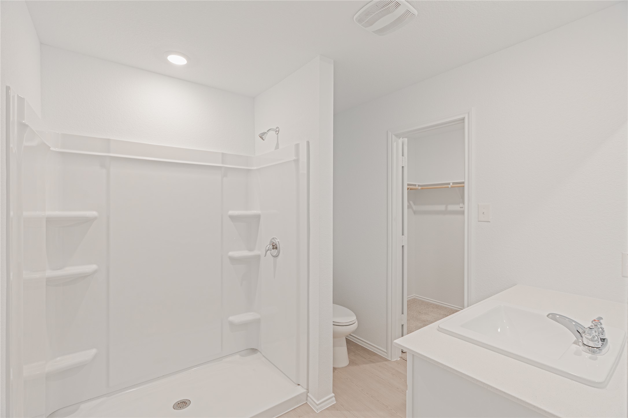 117 Dark Victory Road Jarrell, TX 76537 - Photo 10 of 24 Full bath with a spacious closet, vanity, a shower stall, and light wood-style floors