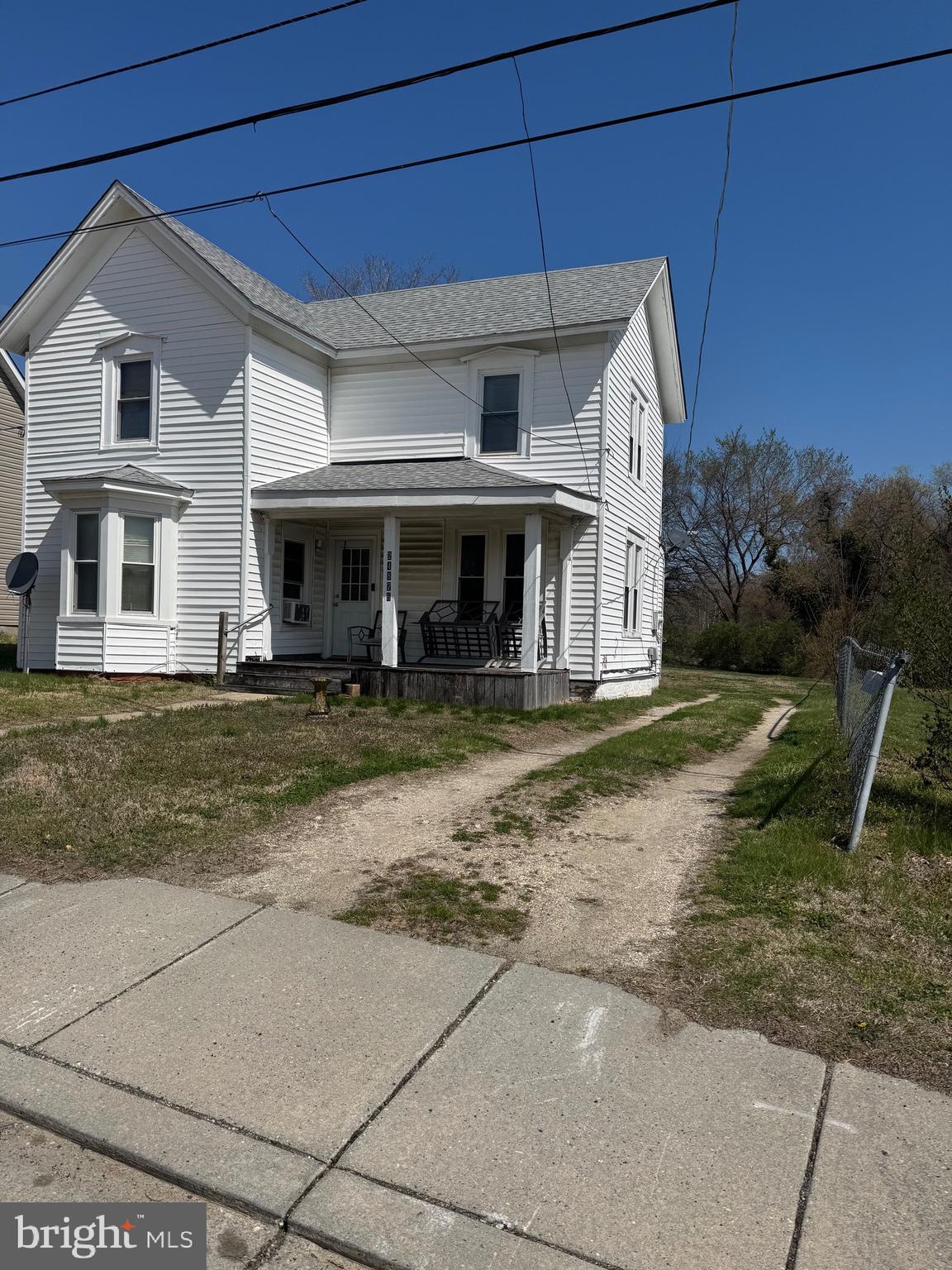 a view of a white house with large windows