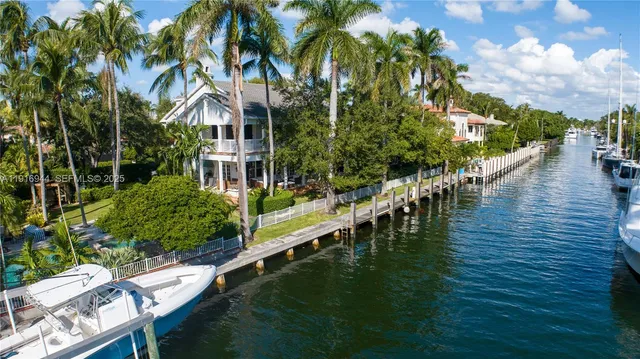 a view of swimming pool with lawn chairs and plants