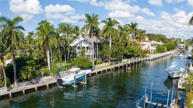a view of house with swimming pool and outdoor seating