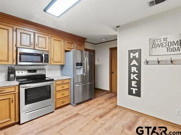 a kitchen with a sink cabinets and window
