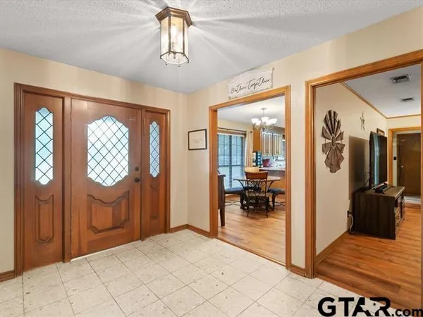 a view of hallway with livingroom and stairs