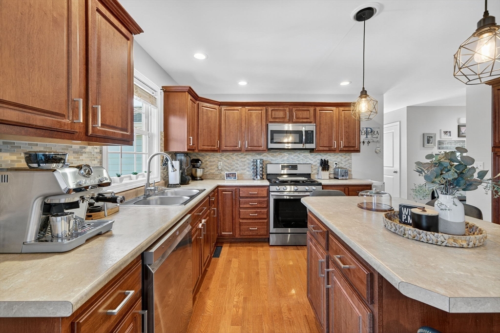 750 Cambridge Street Fall River, MA 02721 - Photo 11 of 38 a kitchen with kitchen island granite countertop a sink a counter top space appliances and cabinets