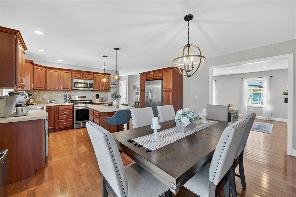 750 Cambridge Street Fall River, MA 02721 - Photo 12 of 38 a view of a dining room and livingroom with furniture wooden floor a rug a chandelier